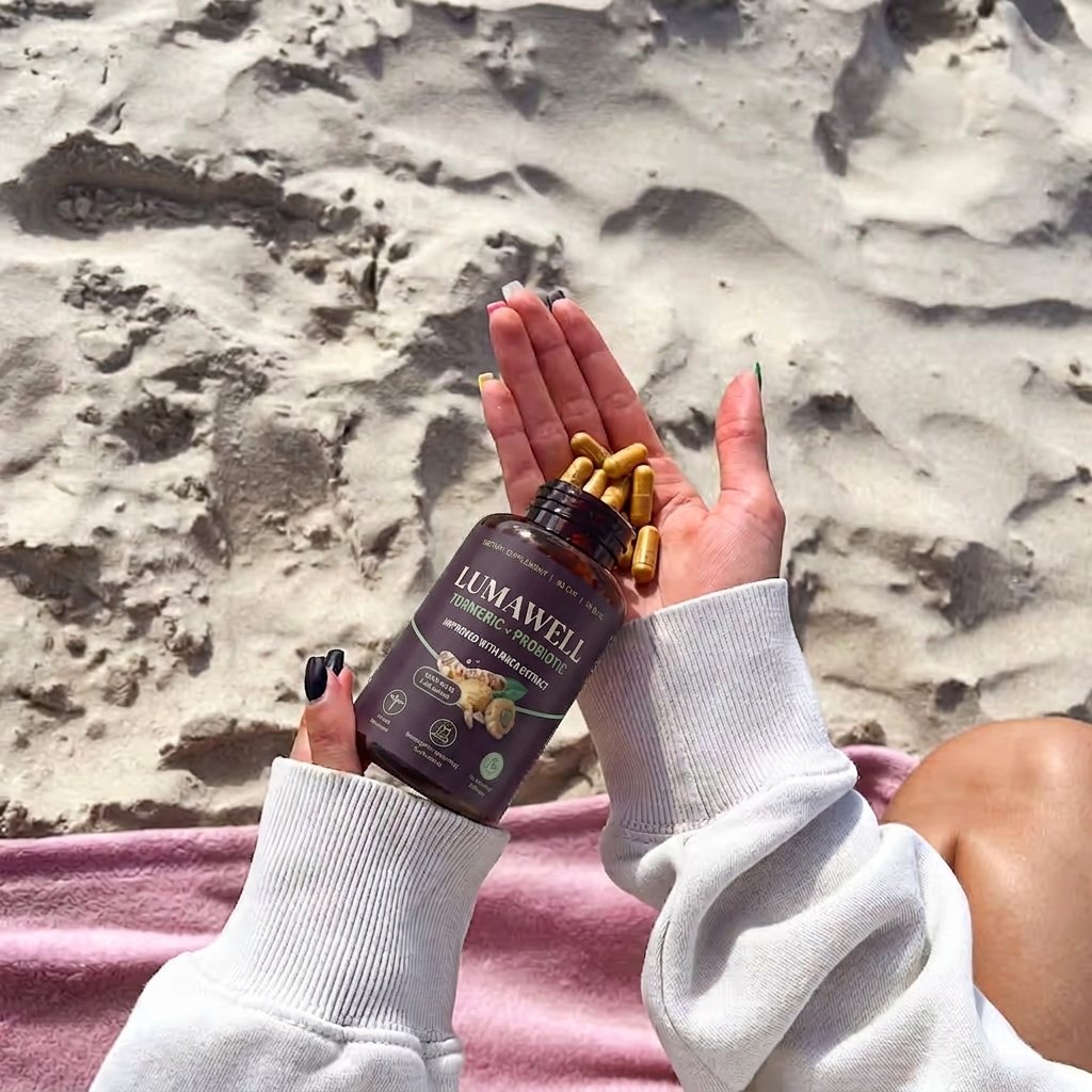 Turmeric + Probiotic capsules in hand